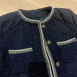 Black Chanel style jacket with gold trim